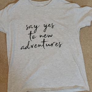 A T shirt that says say yes to new adventures